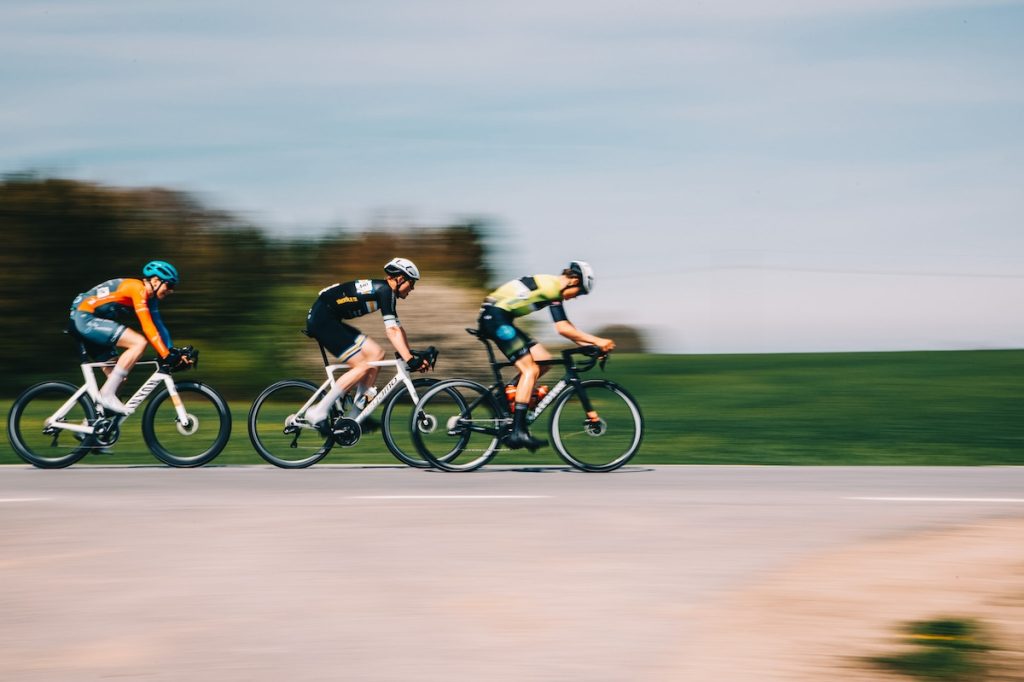 31 Ways to Get Faster on the Bike: The Complete List 4 Cyclists going fast in a race